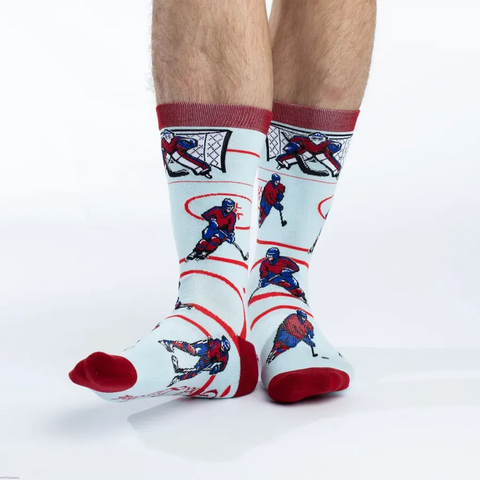 Hockey-themed socks with player and goalie graphics on a white background