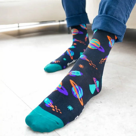 Black socks with colorful space-themed designs on a white background